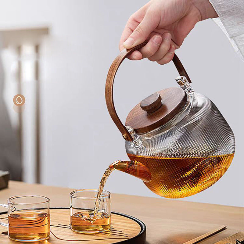 A high borosilicate teapot for brewing tea around a stove