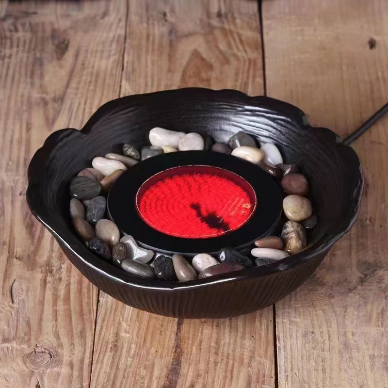 A high borosilicate teapot for brewing tea around a stove