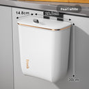 Wall-mounted trash can in the bathroom