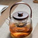 A high borosilicate teapot for brewing tea around a stove