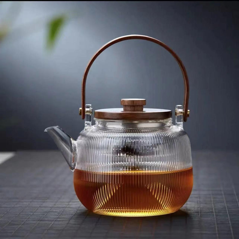 A high borosilicate teapot for brewing tea around a stove
